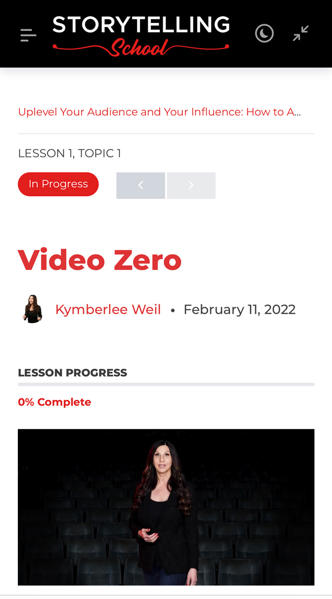 A woman stands in a theater with empty seats, engaging the audience during an online storytelling lesson titled 'Video Zero'.